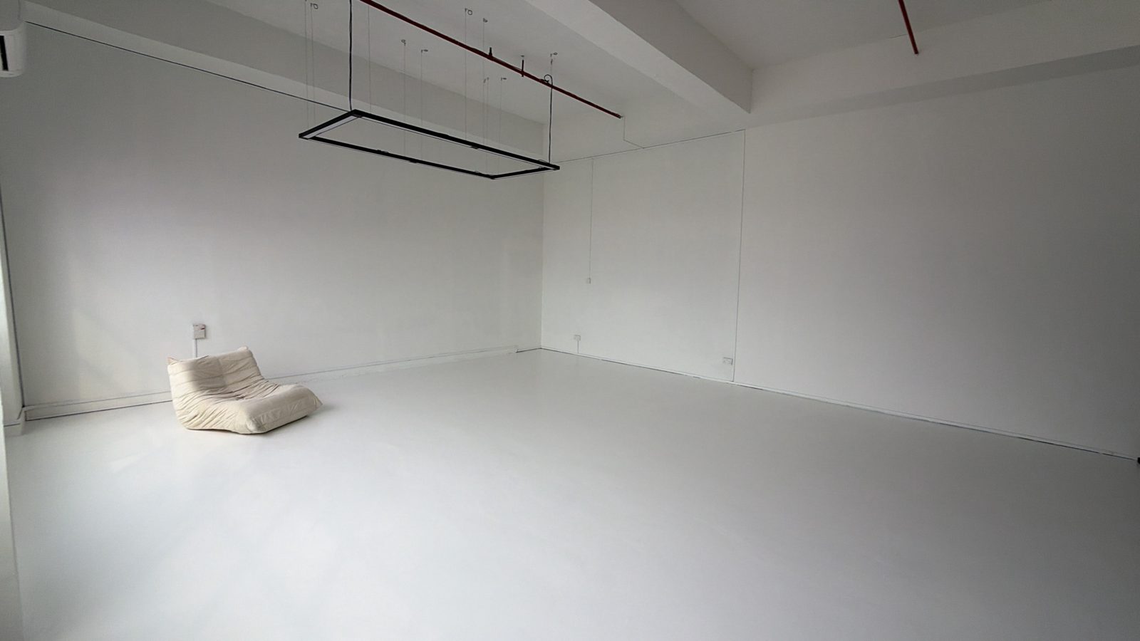 Open white floor with a hanging light frame